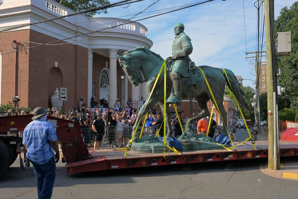 A statue of Confederate general Robert E Lee located in Charlottesvilles is transported away on East Jefferson street after being removed from Market Street Park in Charlottesville, VA on July 10, 2021. Photo: John McDonnell/The Washington Post via Getty Images.