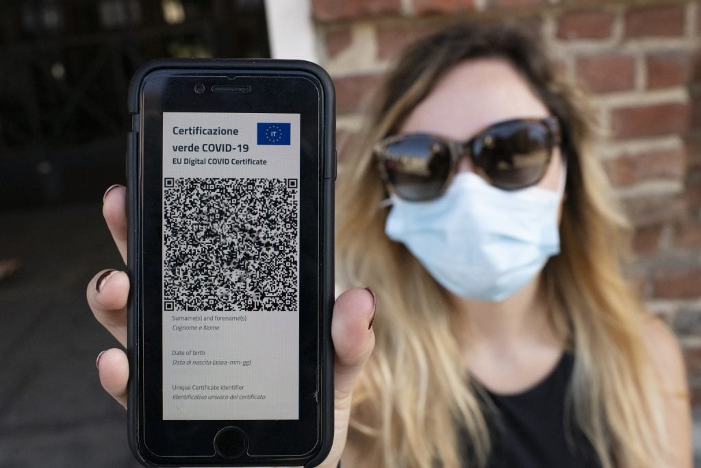 A woman shows Italy's COVID-19 Green Pass for post-vaccine travel on a smartphone on June 30, 2021 in Turin, Italy. The digital health certificate, or Green Pass, was officially launched by Italian Prime Minister Draghi, allowing people to access certain events and facilities in Italy as well as travel domestically and abroad. Photo by Stefano Guidi/Getty Images.