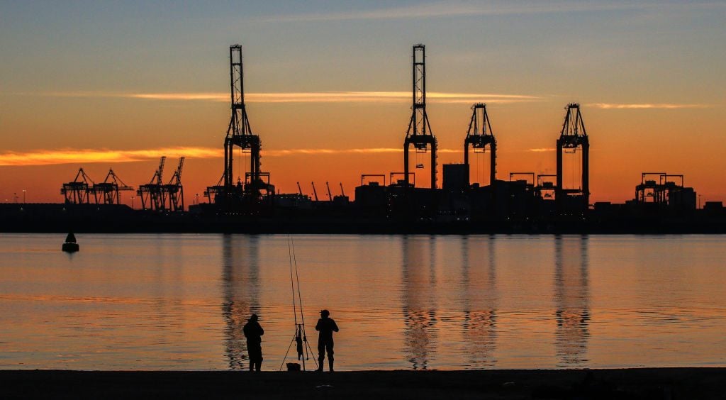 Anglers fish on New Brighton beach as the sun rises over the Port of Liverpool and the River Mersey. (Photo by Peter Byrne/PA Images via Getty Images)