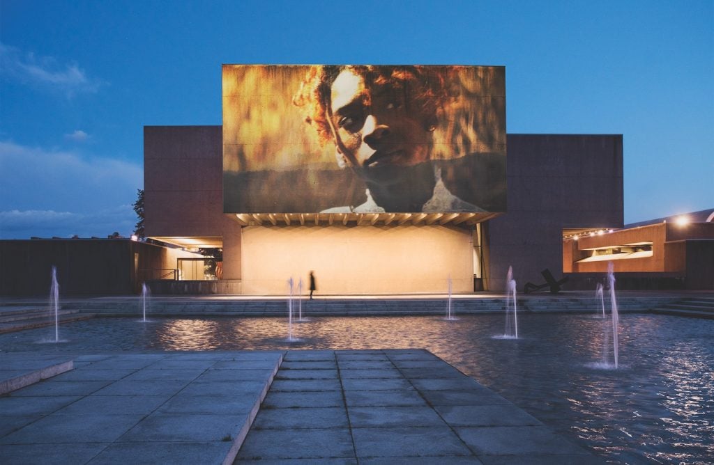 Installation view of "I Dream You Dream of Me" by Jennifer Reeder on Everson Museum facade. Courtesy of Light Work.