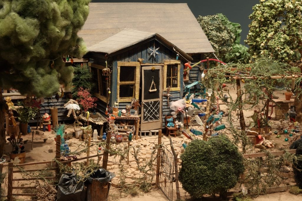 Installation view of “Really Free: The Radical Art of Nellie Mae Rowe” featuring the scale model reimagining of the artist's “playhouse” created for the documentary <em>This World Is Not My Own</em>. Photo by Mike Jensen, courtesy of the High Museum of Art.
