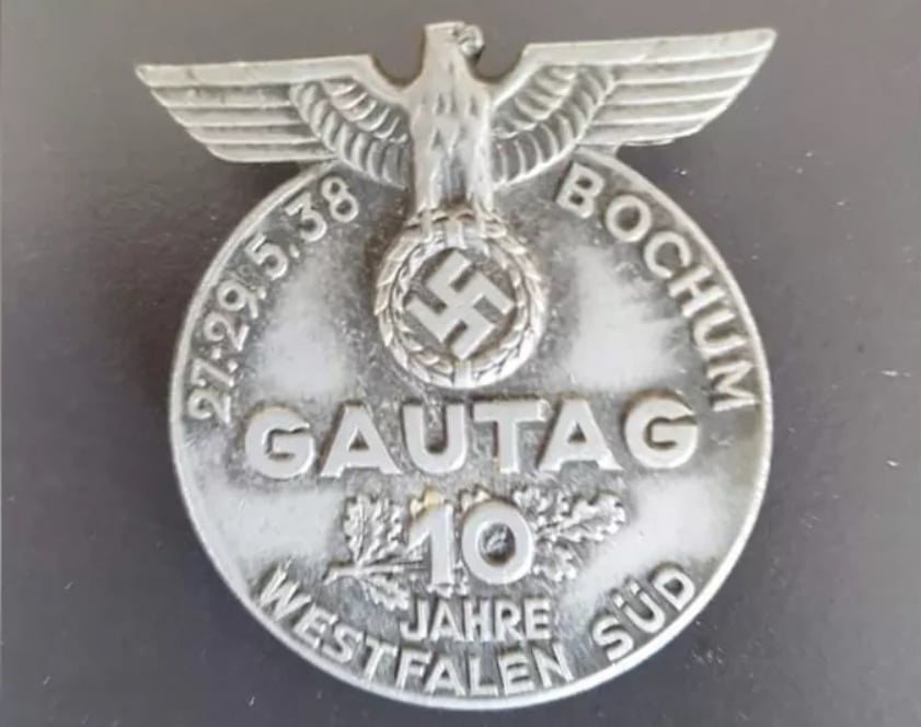 A local history teacher has discovered a secret cache of items, including this  emblem, belonging to the local office of the   Nationalsozialistische Volkswohlfahrt, or NSV, a Nazi welfare agency. Photo courtesy of the Stadtarchiv Hagen.