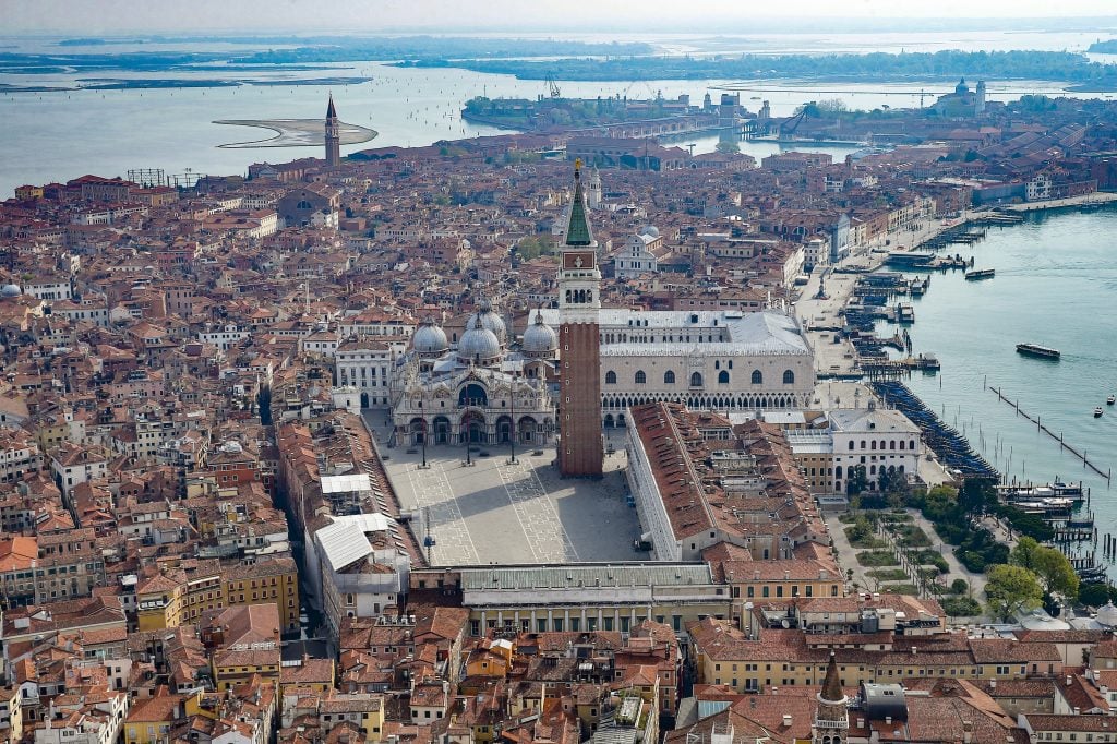 An aerial view from a helicopter of Venice's deserted Piazza San Marco in the center of Venice during the COVID-19 lockdown in April 2020. Photo by Mattia Ozbot/Soccrates Images/Getty Images.