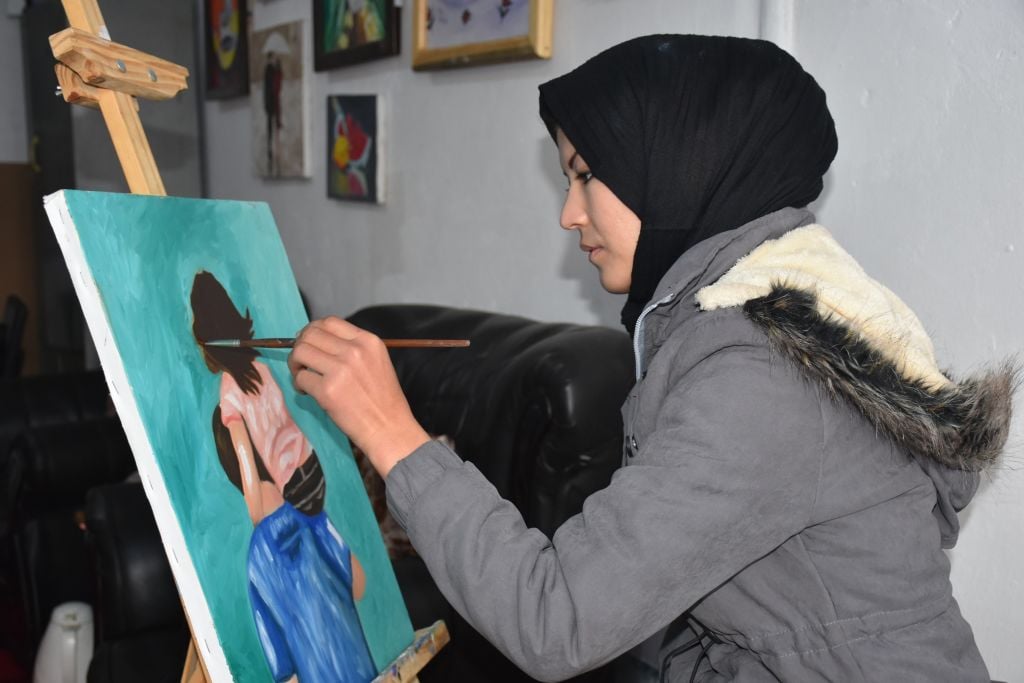 An Afghan girl learns painting at an "Art House for Women" managed by artist Hafiza Mohammadi in Mazar-i-Sharif, capital of northern Balkh province, Afghanistan. Photo by Kawa Basharat/Xinhua via Getty.