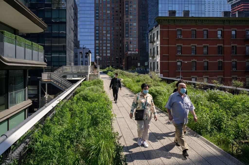 People walk along the High Line in Manhattan, New York city on May 19, 2021. (Photo by ED JONES/AFP via Getty Images)