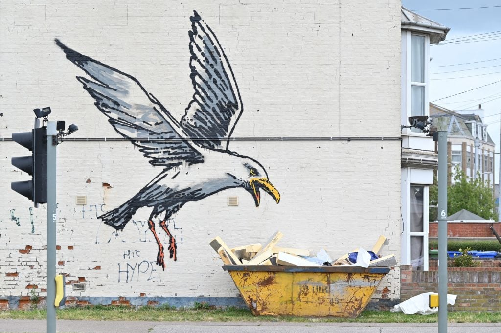 This possible Banksy work of a seagull swooping onto a dumpster in Lowestoft on the East coast of England on August 8, 2021. Photo by Justin Tallis/AFP via Getty Images.
