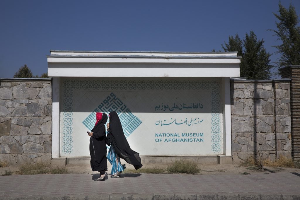 Two women pass by the National Museum of Afghanistan. (Photo by Robert Nickelsberg/Getty Images)