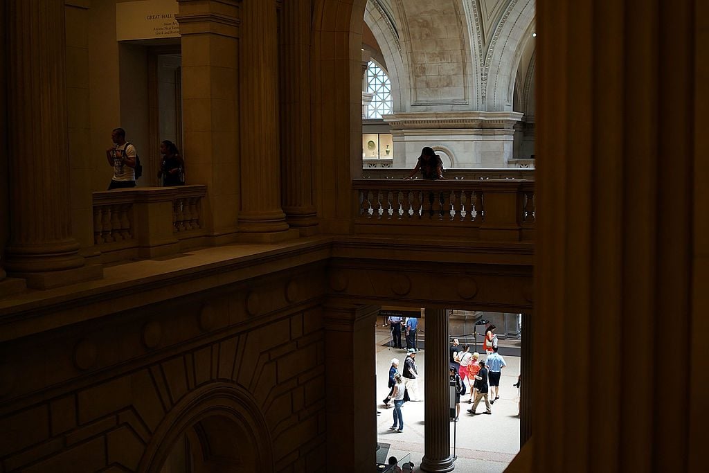 People walk through galleries at the Metropolitan Museum of Art. (Photo by Spencer Platt/Getty Images)
