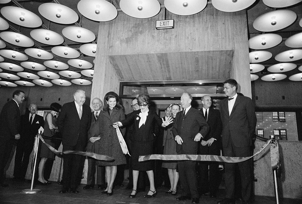 Flora Whitney Miller, president of the Whitney Museum of American Art, cuts the ribbon during the dedication ceremony for the museum's building. Looking on are (from left): the building's architect, Marcel Breuer; Mrs. John F. Kennedy; Lloyd Goodrich, director of the museum, and architect Hamilton Smith.