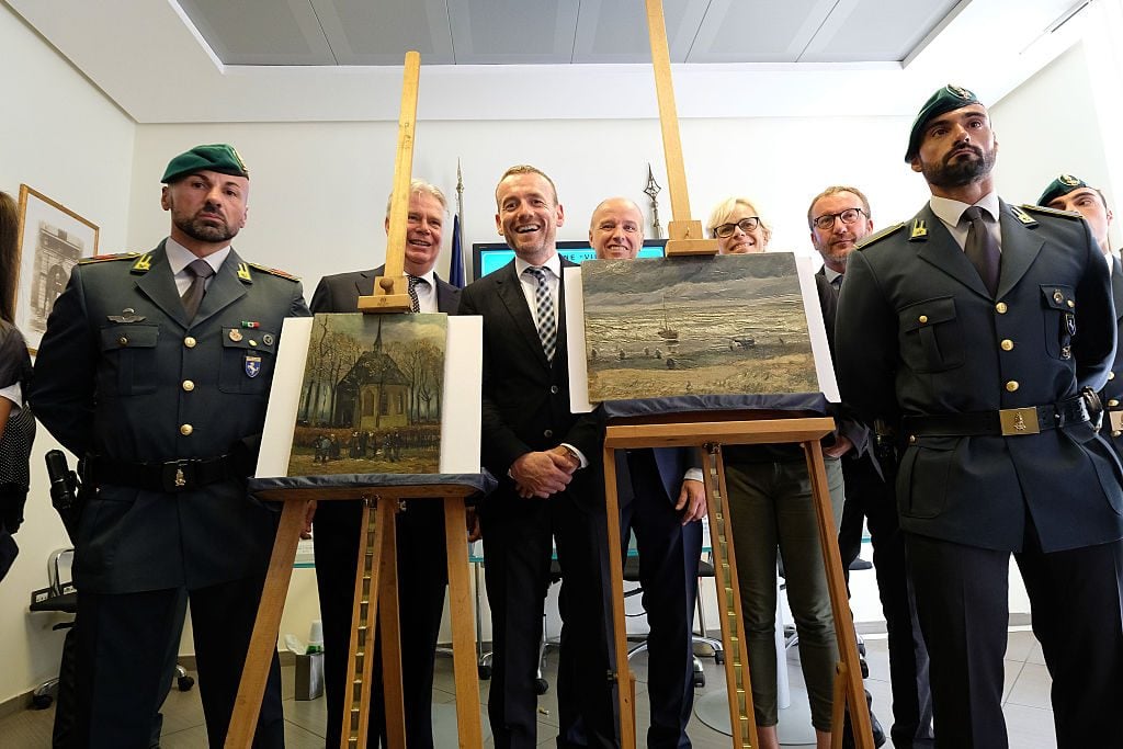 Axel Ruger, director of the Van Gogh Museum, with the two paintings by late Dutch artist Vincent Van Gogh. Stolen in 2002, they were recovered in 2016. Photo by Mario Laporta/AFP via Getty Images.