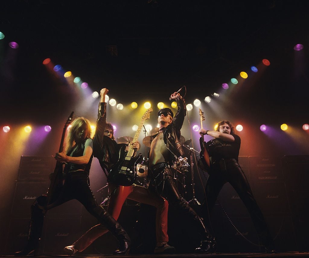 Left to right: K.K. Downing, Glenn Tipton, Rob Halford and Ian Hill of Judas Priest perform on stage - Unleashed In The East album cover session taken in July 1979. (Photo by Fin Costello/Redferns)
