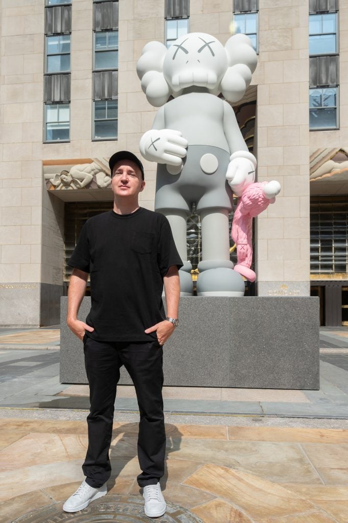 The artist KAWS unveils his new sculpture SHARE at Rockefeller Center in New York. The 18-foot-tall bronze figure features two of the artist's iconic motifs, "COMPANION" and "BFF." Photo by Diane Bondareff, courtesy of AP Images for Tishman Speyer.