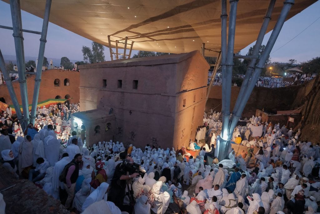 Thousands of pilgrims attend the Orthodox Christmas or Gena ceremony at Bete Mariam (Saint Mary's Church) during Orthodox Christmas/Gena celebrations on January 7, 2019 in Lalibela, Ethiopia. (Photo by J. Countess/Getty Images)