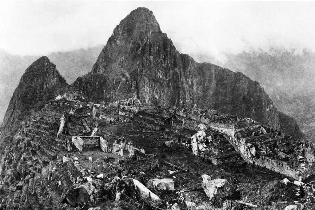 A 1912 photograph of Machu Picchu by Yale professor Hiram Bingham III, who rediscovered the city a year earlier. Photo by Hiram Bingham III, <em>National Geographic</em>, public domain.