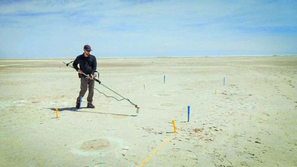 Thomas Urban conducts magnetometer survey of mammoth footprints at White Sands. Photo by David Bustos, courtesy of White Sands National Park, New Mexico.