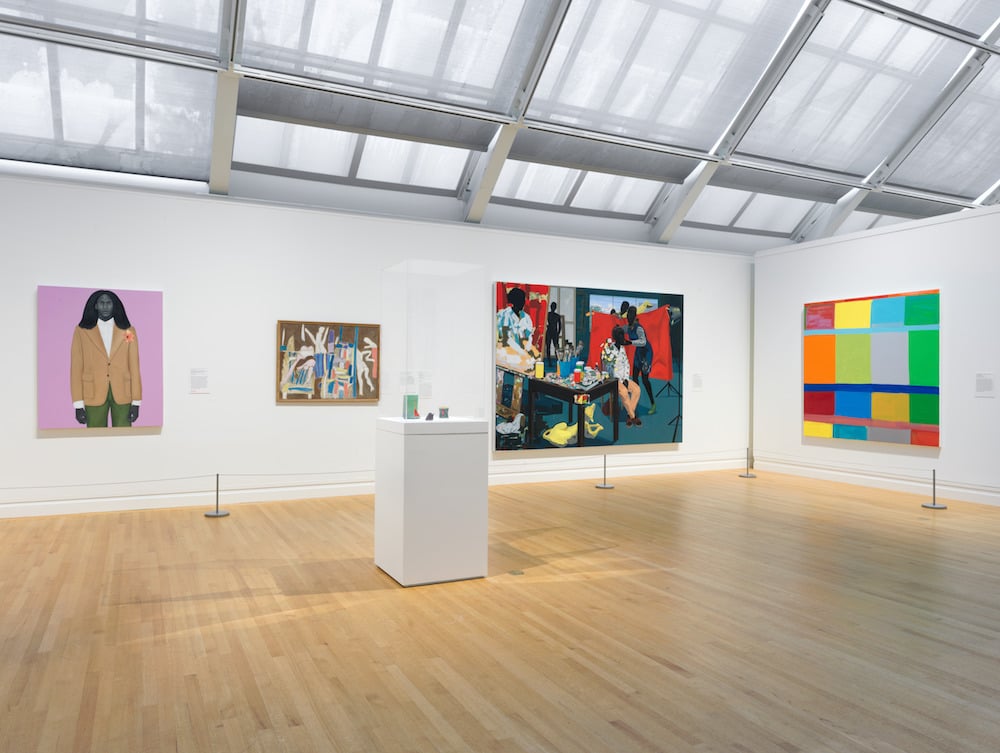 The Met's Modern and contemporary galleries. From left to right: Amy Sherald, <i>When I let go of what I am, I become what I might be (Self-imagined atlas)</i> (2018); K.G. Subramanyan, <i>Studio Table With Figure I</i> (1965); Kerry James Marshall, <i>Untitled (Studio</i> (2014); Stanley Whitney, <i>Fly the Wild</i> (2017); Center vitrine: Ron Nagle, <i>Watermelon</i> (1983); <i>Contessa</i> (1983); <i>Untitled</i> (1991). Photo courtesy of the Metropolitan Museum of Art.