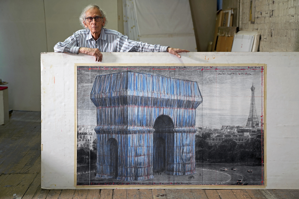 Christo in his studio with a preparatory drawing for "L'Arc de Triomphe, Wrapped. "New York City, September 20, 2019. Photo: Wolfgang Volz. ©2019 Christo and Jeanne-Claude Foundation.
