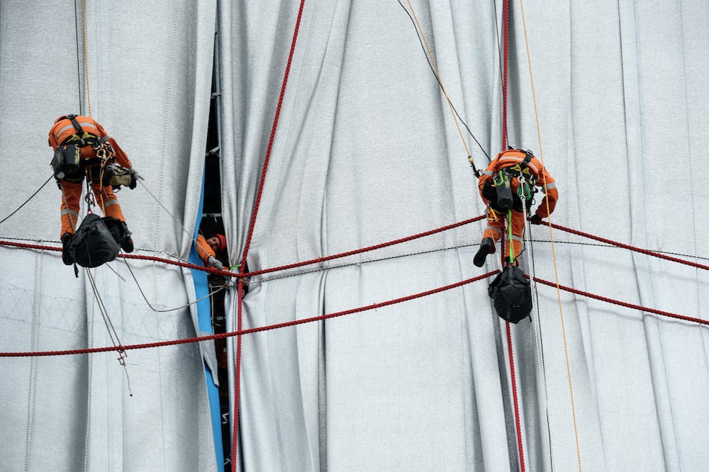 Ropes are being installed to secure and contour the fabric on the Arc de Triomphe Paris, September 14, 2021. Photo: Benjamin Loyseau. ©2021 Christo and Jeanne-Claude Foundation.