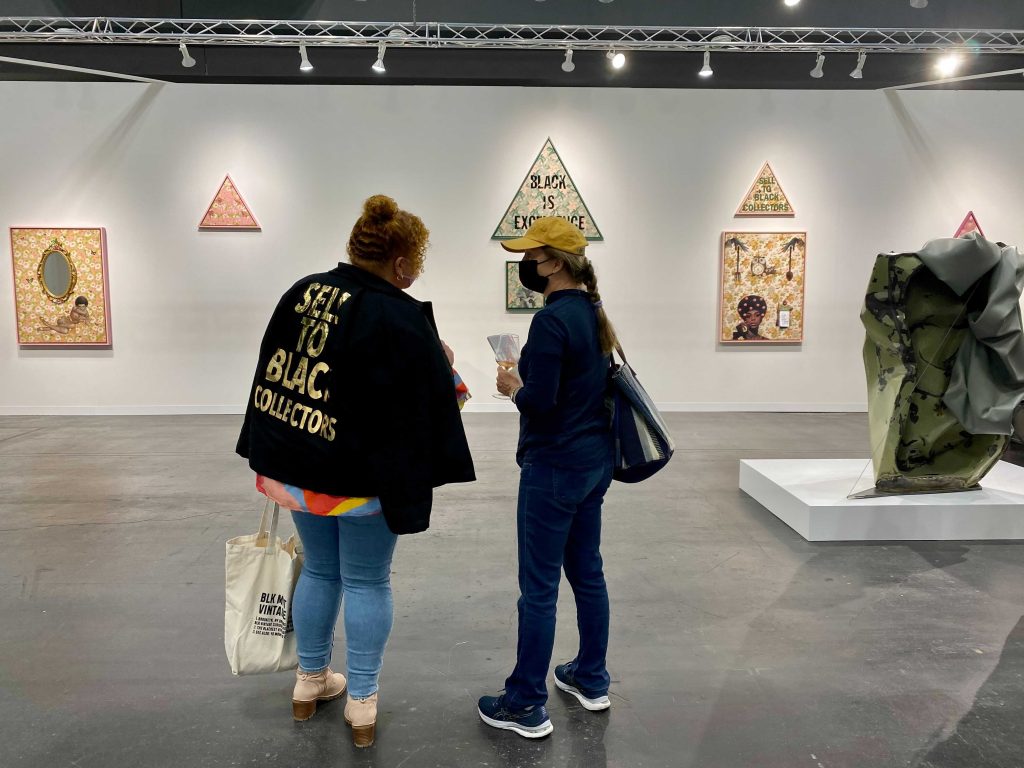 Genevieve Gaignard (left) in front of her work at Vielmetter, Los Angeles, at the 2021 Armory Show at the Javits Center in New York. Photo by Sarah Cascone.
