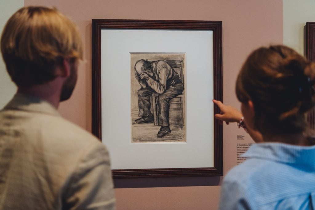 Visitors at the Van Gogh Museum in Amsterdam stare at the Dutch artist's 1882 sketch, Study for ‘Worn out’. Photo: Jelle Draper. Courtesy of the Van Gogh Museum.