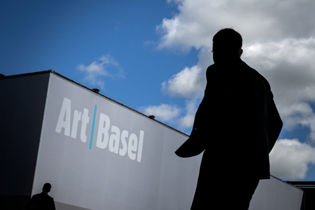 A visitor arrives at the 2019 edition of Art Basel, the last in-person version of the fair. (Photo by Fabrice Coffrini/AFP via Getty Images.)