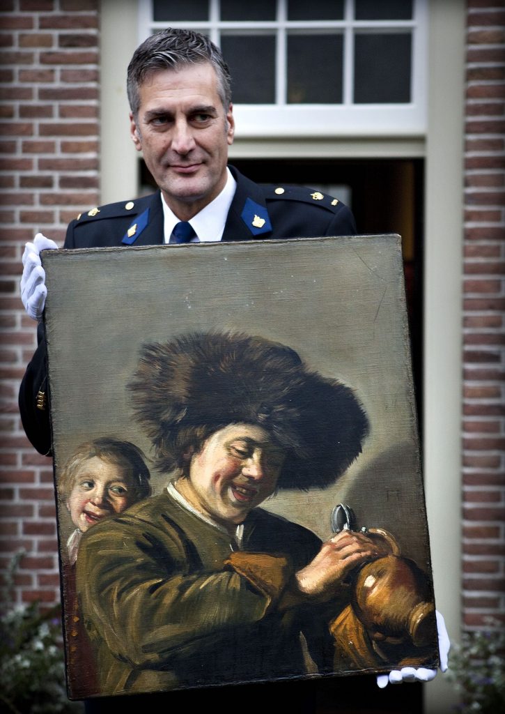 District Chief of Alblasserwaard Bart Willemsen showing the recovered painting Two Laughing Boys by Frans Hals which was stolen from the Leerdam Museum in May 2011. (Photo by Ilvy Njiokiktjien/ANP/AFP via Getty Images)
