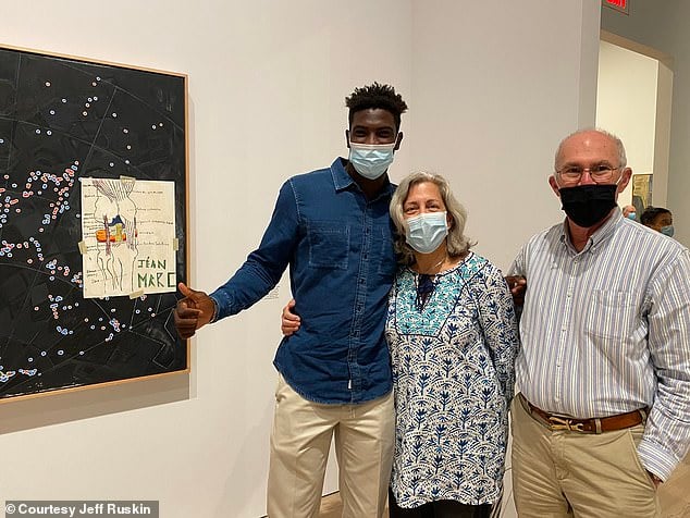Jéan-Marc Togodgue and his host parents, Rita Delgado and Jeff Ruskin, with Jasper Johns's <em>Slice</em> at the Whitney Museum of American Art in New York. Photo courtesy of Jeff Ruskin. 