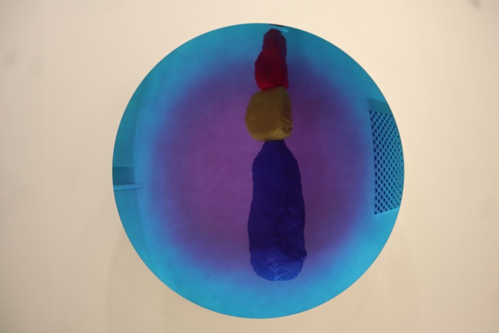 Work by Ugo Rondinone reflected in an Anish Kapoor at Kamel Mennour at FIAC 2021. Photo by Naomi Rea.