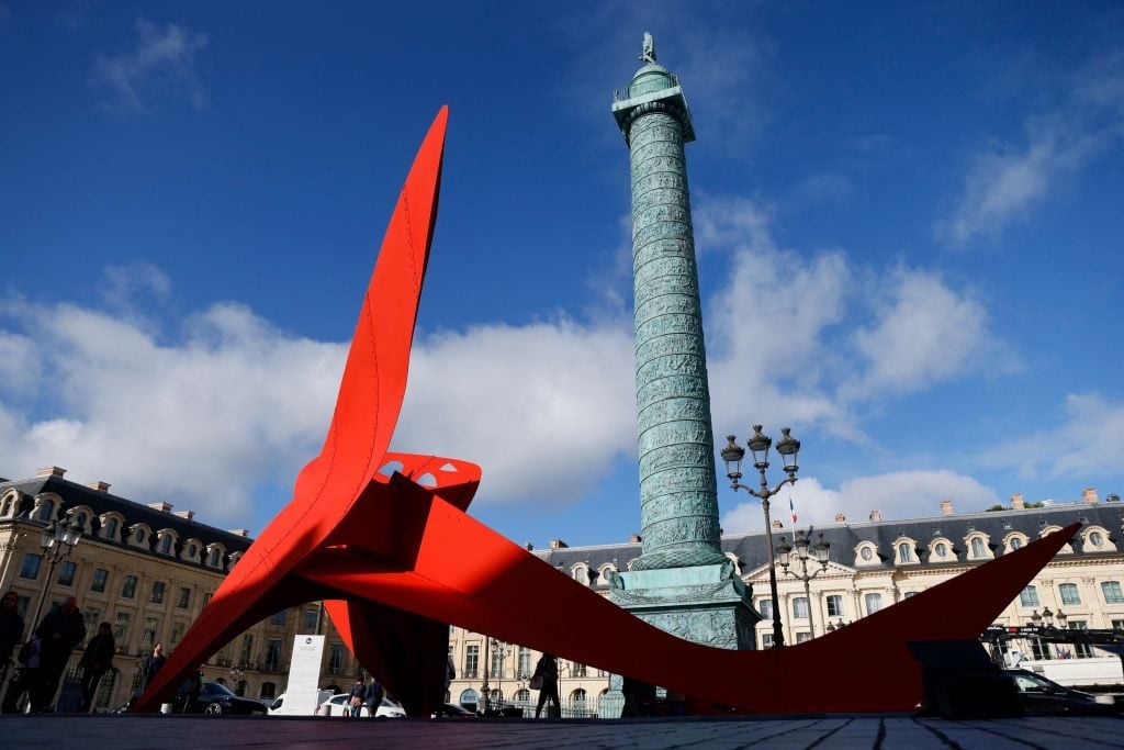 Pedestrians walk past the Flying Dragon, an artwork by US sculptor Alexander Calder displayed on the Place Vendome in Paris, as part of the FIAC, the French International Contemporary Art Fair, on October 21, 2021. Photo by Thomas Samson/AFP via Getty Images.