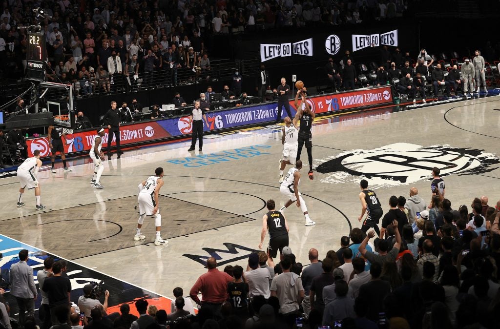The Brooklyn Nets playing at the Barclays Center, with Basquiat-themed jerseys and floor decor. (Photo by Elsa/Getty Images)