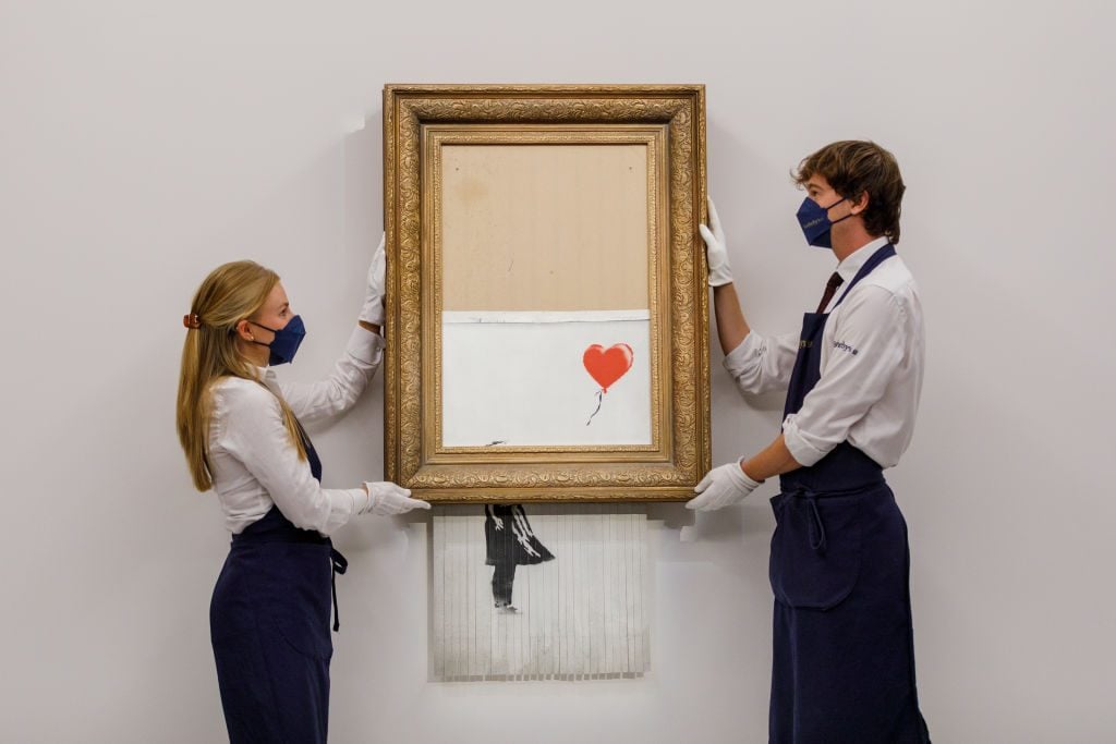 Banksy's Love is in the Trash (2018) at Sotheby's London on September 3, 2021. (Photo by Tristan Fewings / Getty Images for Sotheby's)