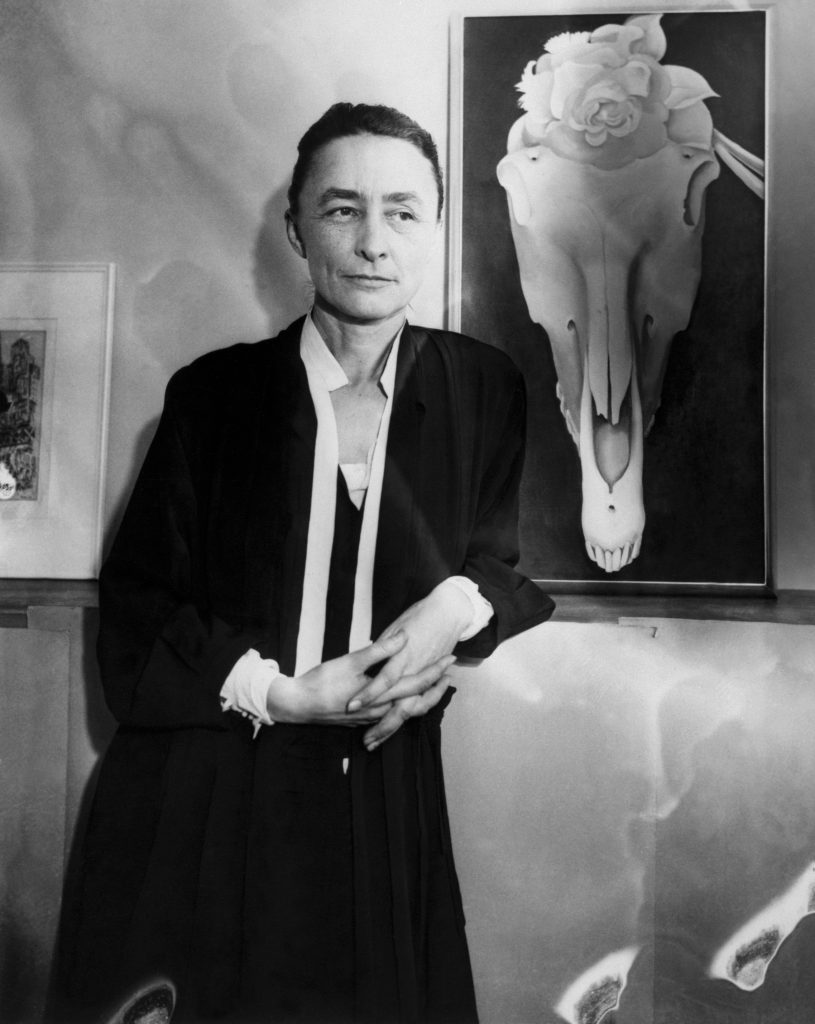 Artist Georgia O'Keeffe stands next to her painting <i>Horse Skull With White Rose</i>. Credit: Bettmann/ Contributor, Getty Images