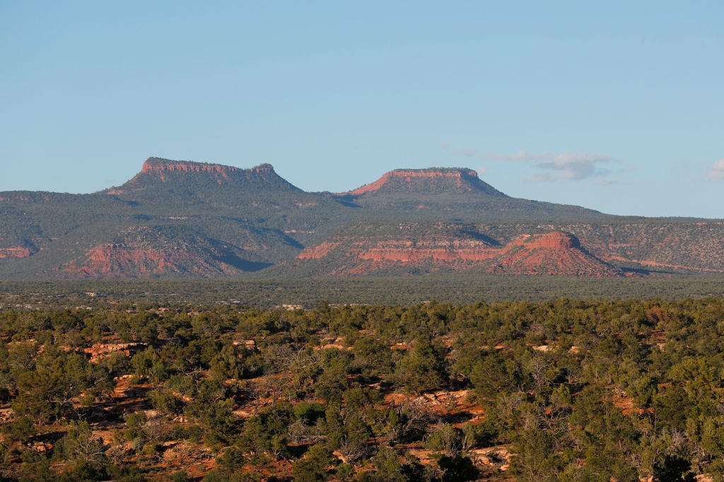 The two bluffs known as the "Bears Ears" stand off in the distance at sunset in the Bears Ears National Monument on May 11, 2017 outside Blanding, Utah. Photo: George Frey/Getty Images.