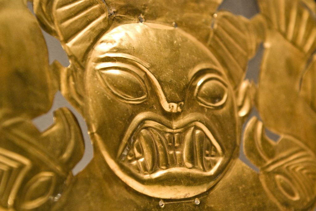 Frontal adornment of 18-karat gold headdress depicting a feline head with half-moon headdress and two birds (ca. 1 AD–800 AD). Collection of the Museo Larco, Lima, Peru. Photo courtesy of World Heritage Exhibitions.