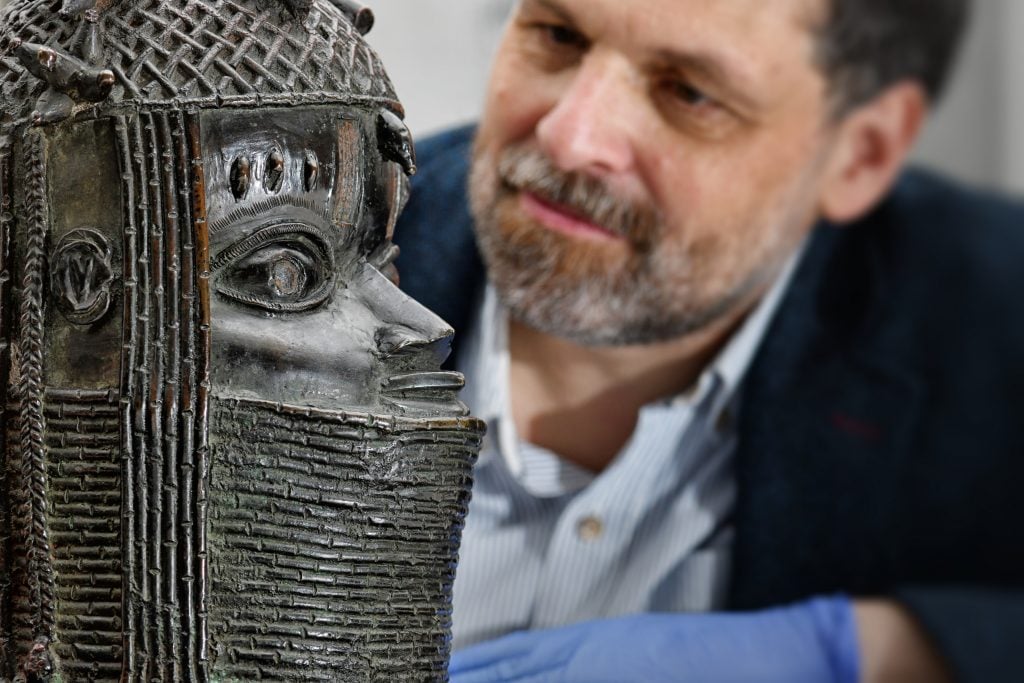 Neil Curtis, head of museums and special collections at the University of Aberdeen, with the Benin Bronze. Courtesy of the University of Aberdeen.