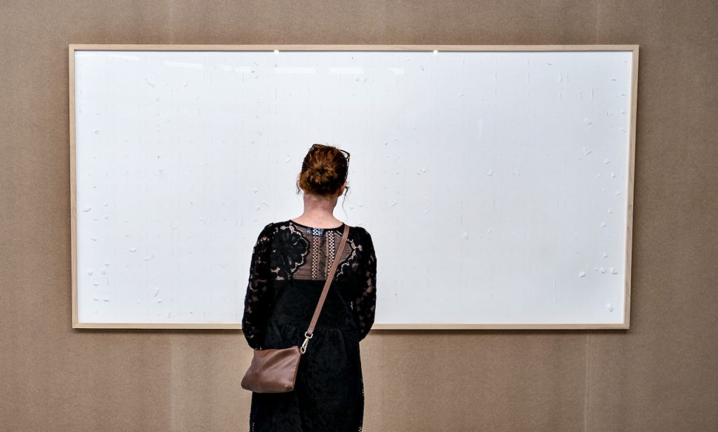 A woman stands in front of an empty frame hung up at the Kunsten Museum in Aalborg, Denmark, on September 28 2021 (Photo by Henning Bagger/Ritzau Scanpix/AFP via Getty Images)