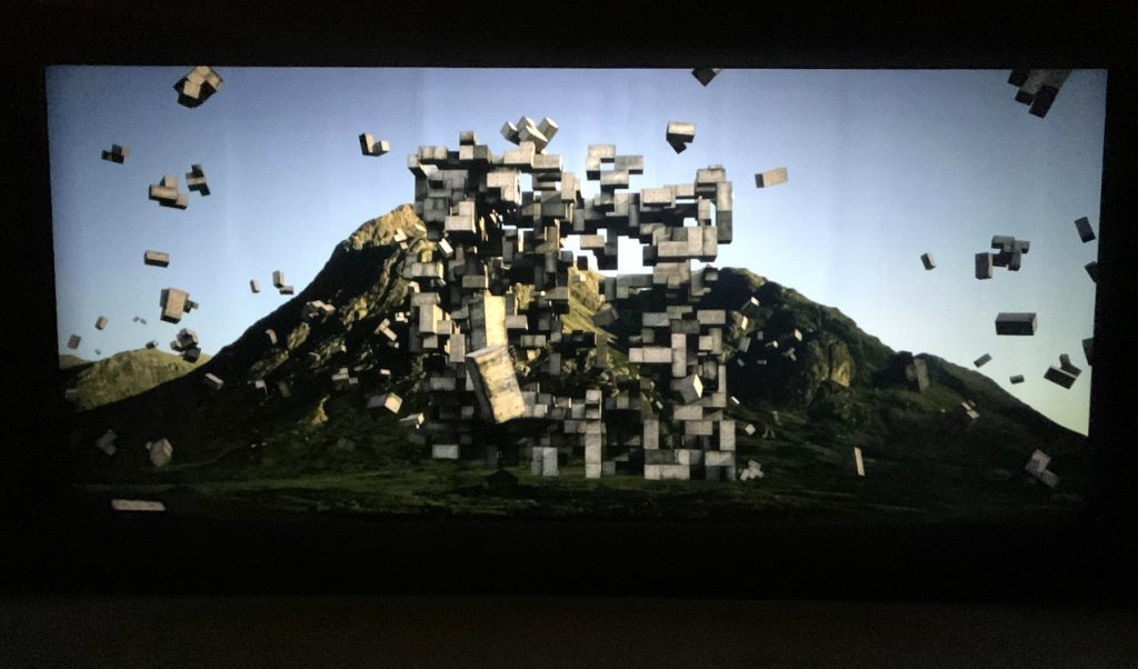 Stone blocks assemble in a film shown in "Fragile Future" at the Shed. Photo by Ben Davis.
