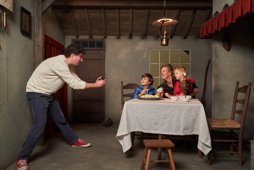 Visitors to the Van Gogh Museum in Amsterdam pose in a reconstruction of the cottage in Vincent Van Gogh's 1885 painting <i>The Potato Eaters</i> in a new exhibition dedicated to the work. Photo by Tomek Dersu Aaron, courtesy of the Van Gogh Museum, Amsterdam.