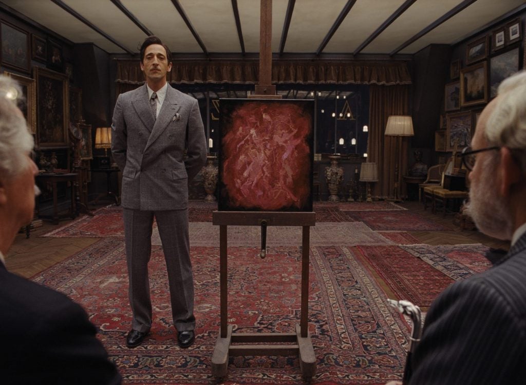 Adrien Brody as Julian Cadazio with Moses Rosenthaler's <eM>Simone Naked, Cell Block J. Hobby Room</eM> in <em>The French Dispatch</em>. Photo courtesy of Fox Searchlight Pictures.