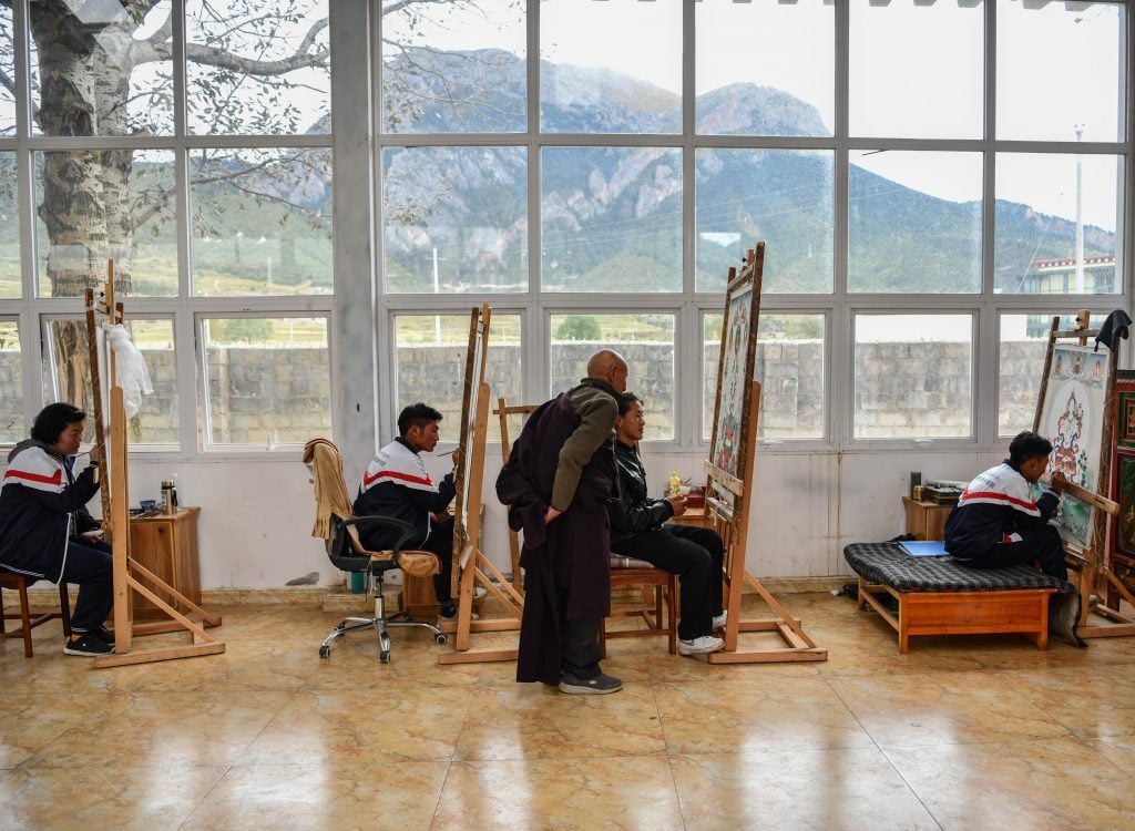 Students learn thangka painting at art school. (Xinhua/Jigme Dorje via Getty Images)