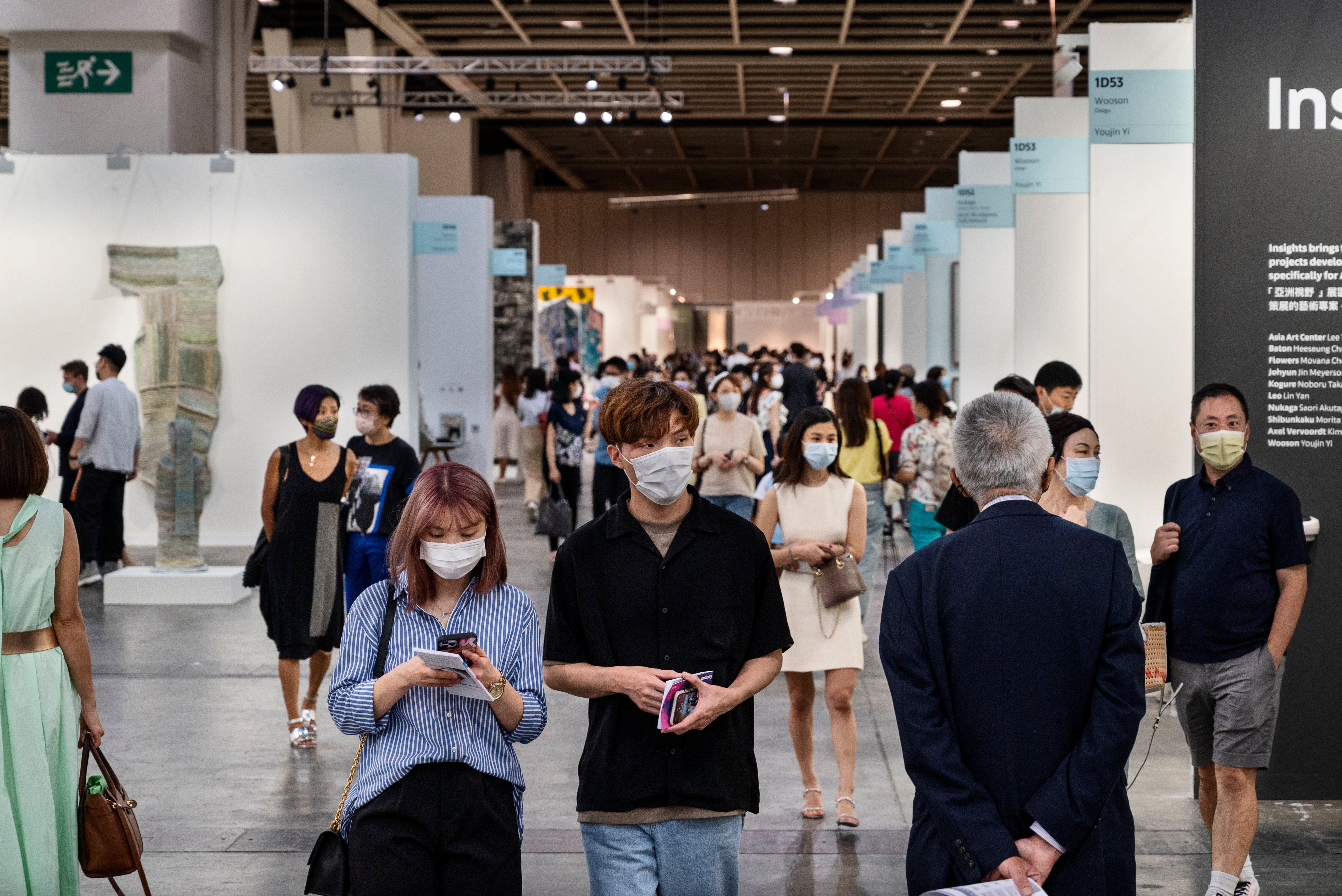 Guests seen during the Art Basel Hong Kong at the convention and exhibition center in 2021. Photo by Miguel Candela/SOPA Images/LightRocket via Getty Images.