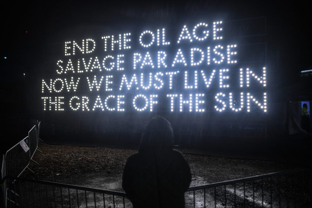 'End The Oil Age Salvage Paradise Now We Must Live In The Grace Of The Sun' designed by artist Robert Montgomery and Little Sun, in partnership with Octopus Energy and MTArt Agency. (Photo by Peter Summers/Getty Images)