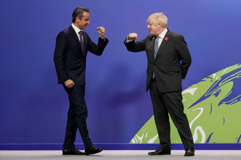 British Prime Minister Boris Johnson (R) greets Greek Prime Minister Kyriakos Mitsotakis as they arrive for day two of COP26 at SECC on November 1, 2021 in Glasgow, Scotland. Photo by Christopher Furlong/Getty Images.