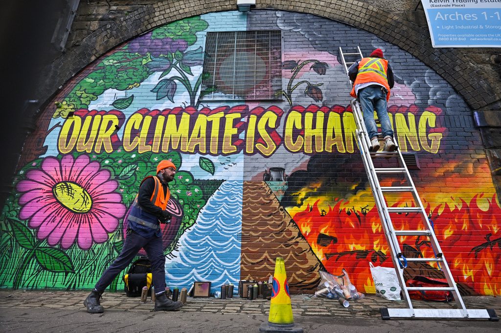  Artists paint a mural, part of the Grantham Climate Art Prize organized by the Grantham Institute near Scottish Events Centre (SEC) which will be hosting the COP26 UN Climate Summit. (Photo by Jeff J Mitchell/Getty Images)