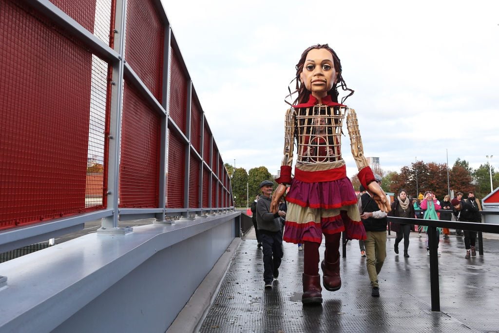 Little Amal arrives at Old Trafford on November 3, in Manchester, England. Photo: Charlotte Tattersall/Getty Images.