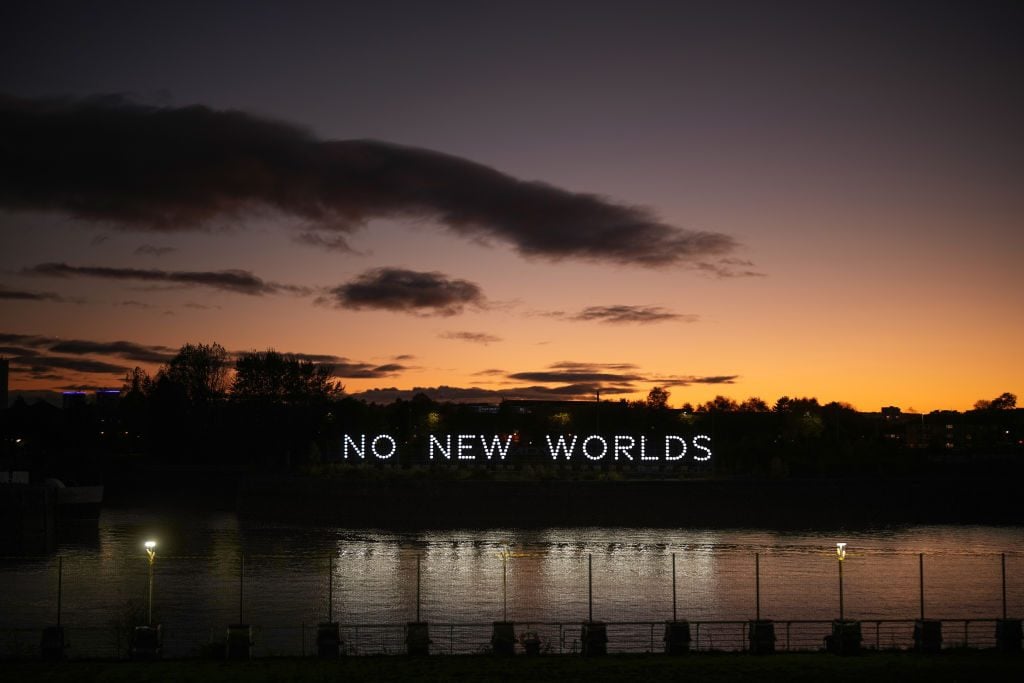 An LED installation by artist collective Still/Moving projects a message across the River Clyde to delegates attending COP26 on November 03, 2021 in Glasgow, Scotland. Photo: Christopher Furlong/Getty Images.