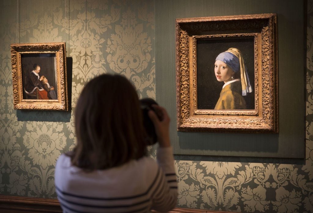 Johannes Vermeer's Girl with a Pearl Earring (ca.1665) in the Vermeer Room in the Mauritshuis Museum in The Hague, Netherlands. Photo by Michel Porro/Getty Images.