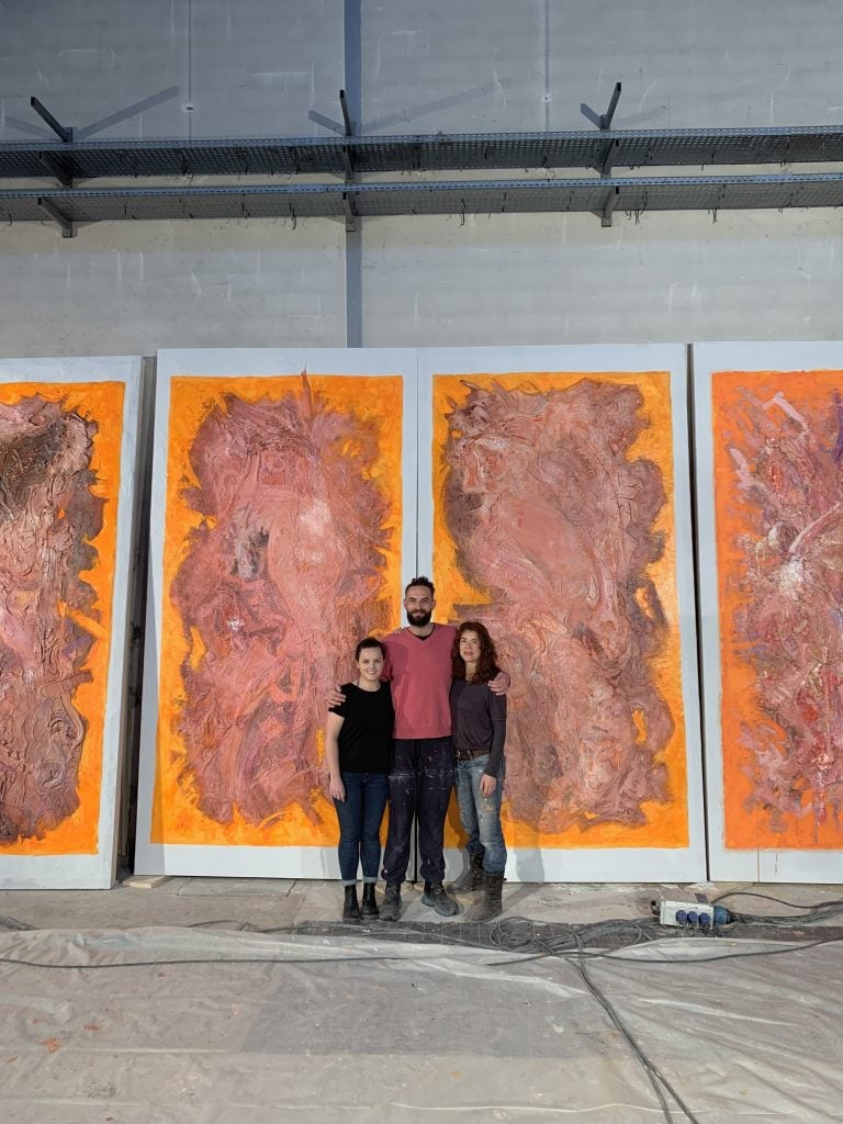 Sian Smith, Sandro Kopp, and Edith Baudraud with the paintings for <em>The French Dispatch</em>. Photo courtesy of Sian Smith. 