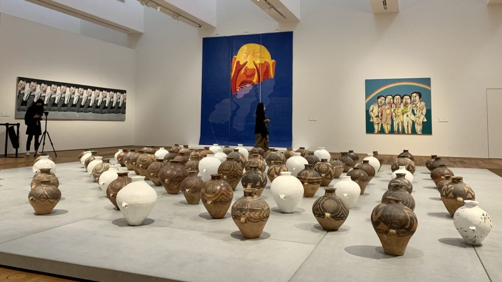 M+ Sigg Collection exhibition: (Front)Whitewash (1995–2000) Ai Weiwei. (Back, left to right). Everybody Connects to Everybody (1997) Yue Minjun. 1996.1B (1996) Fang Lijun. Mask: Rainbow (1997) Zeng Fanzhi. Photo: Rachel Wong.