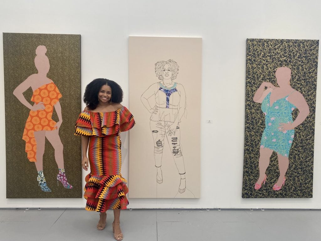 Gio Swaby with three of her works at New York gallery Claire Oliver's sold out booth at UNTITLED Art Fair in Miami Beach. Photo by Sarah Cascone.